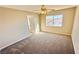 Neutral bedroom with carpeted floor, ceiling fan and a bright window with neighborhood view at 7244 Buglehorn St, Las Vegas, NV 89131