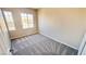 Comfortable carpeted bedroom featuring large windows with neighborhood views at 7244 Buglehorn St, Las Vegas, NV 89131