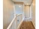 Bright hallway with carpet flooring, white railing, and neutral walls at 7244 Buglehorn St, Las Vegas, NV 89131