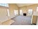 Open-concept living room with fireplace, neutral carpeting, and abundant natural light at 7244 Buglehorn St, Las Vegas, NV 89131