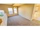 Cozy living area featuring neutral colors, a chandelier, and multiple windows for natural light at 7244 Buglehorn St, Las Vegas, NV 89131