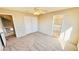 Neutral main bedroom featuring carpeted floor, ceiling fan, and access to the bathroom at 7244 Buglehorn St, Las Vegas, NV 89131