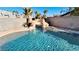 Sparkling pool with rock waterfall offers a serene backyard oasis with lush landscaping at 7244 Buglehorn St, Las Vegas, NV 89131