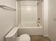 Bathroom with a shower-tub combo and white tiled walls at 7325 Sunray Point St, North Las Vegas, NV 89084