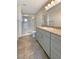 Modern bathroom with granite countertops, gray cabinets, and glass shower at 7325 Sunray Point St, North Las Vegas, NV 89084