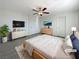 Bright bedroom featuring a ceiling fan, mounted TV, and neutral decor at 7325 Sunray Point St, North Las Vegas, NV 89084