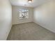 A cozy bedroom featuring neutral carpet and a window with classic white shutters at 7325 Sunray Point St, North Las Vegas, NV 89084