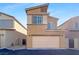 Charming two-story home with stucco facade, two-car garage, and desert landscaping at 7325 Sunray Point St, North Las Vegas, NV 89084