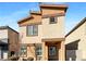 Inviting two-story home with tan stucco, contrasted with brown trim, and a red tile roof at 7325 Sunray Point St, North Las Vegas, NV 89084