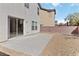 Backyard featuring a concrete patio, low-maintenance landscaping, and a sliding glass door at 7452 Wine Creek St, Las Vegas, NV 89139