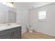 Bathroom featuring tile flooring, single-sink vanity, mirror and a window at 7452 Wine Creek St, Las Vegas, NV 89139