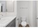 Updated bathroom features a toilet, a modern vanity, and white walls at 7452 Wine Creek St, Las Vegas, NV 89139