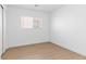 Light bedroom featuring wood-look flooring and window with horizontal blinds at 7452 Wine Creek St, Las Vegas, NV 89139