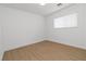 Light-filled bedroom features laminate floors and a window with white blinds at 7452 Wine Creek St, Las Vegas, NV 89139