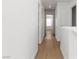 Well-lit hallway with wood floors, connecting different areas of the home at 7452 Wine Creek St, Las Vegas, NV 89139