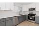 Well-lit kitchen featuring stainless steel appliances and stylish gray cabinets at 7452 Wine Creek St, Las Vegas, NV 89139