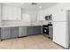 Bright kitchen features gray lower cabinets, white upper cabinets and stainless steel appliances at 7452 Wine Creek St, Las Vegas, NV 89139