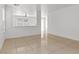 Bright living room with neutral tile flooring and all-white walls at 7452 Wine Creek St, Las Vegas, NV 89139