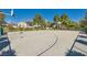 Outdoor basketball court in fenced recreational area with mature trees offers residents activity at 7835 Meandering Path Ave, Las Vegas, NV 89131