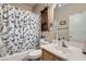 Well-maintained bathroom with shower, vanity, and storage at 7835 Meandering Path Ave, Las Vegas, NV 89131