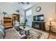 Cozy living room featuring vaulted ceiling, fireplace, and access to patio at 7835 Meandering Path Ave, Las Vegas, NV 89131