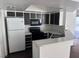 Bright kitchen featuring white countertops, and modern appliances, and black cabinets at 8600 W Charleston Blvd # 2195, Las Vegas, NV 89117