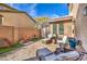 Backyard patio features stylish outdoor seating and an inviting fireplace with a privacy wall at 9037 Wolf Dancer Ave, Las Vegas, NV 89143