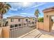 Sunny balcony with decorative railing offering neighborhood views and palm trees at 9037 Wolf Dancer Ave, Las Vegas, NV 89143