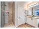 Bathroom featuring tiled shower with built-in niche and vanity with drawers at 9037 Wolf Dancer Ave, Las Vegas, NV 89143