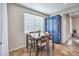 Well-lit dining area featuring a wood table with bar-stool seating and a blue storage cabinet at 9037 Wolf Dancer Ave, Las Vegas, NV 89143