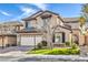 Charming two-story home featuring an attached two car garage and manicured front lawn at 9037 Wolf Dancer Ave, Las Vegas, NV 89143