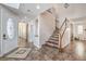 Bright foyer features decorative tile flooring, a striking staircase, and a stylish front door at 9037 Wolf Dancer Ave, Las Vegas, NV 89143