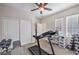 Well-equipped home gym with treadmill, weights, and ample space for fitness activities at 9037 Wolf Dancer Ave, Las Vegas, NV 89143