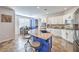 Well-lit eat-in kitchen featuring an island with bar stools, stainless appliances and eat-in dining area at 9037 Wolf Dancer Ave, Las Vegas, NV 89143