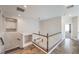 Upstairs landing with tiled floors, built-in shelving, and decorative light fixture at 9037 Wolf Dancer Ave, Las Vegas, NV 89143