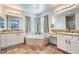 Bright main bathroom features dual sinks, a soaking tub, and a serene atmosphere at 9037 Wolf Dancer Ave, Las Vegas, NV 89143