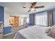 Comfortable main bedroom with ensuite bath featuring a barn door and ample natural light at 9037 Wolf Dancer Ave, Las Vegas, NV 89143