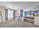 Spacious main bedroom featuring a platform bed area, stylish decor, and plenty of natural light at 9037 Wolf Dancer Ave, Las Vegas, NV 89143