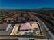 Aerial view of a home with a pool, pergola and desert landscaping near a drainage basin at 9091 Becket Ranch Ct, Las Vegas, NV 89113