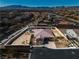 Aerial view of home with desert landscaping, pool, spa, and mountain views at 9091 Becket Ranch Ct, Las Vegas, NV 89113