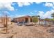 Single story home backyard featuring lounge chairs and a pool, with desert landscaping at 9091 Becket Ranch Ct, Las Vegas, NV 89113