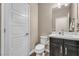 Powder room featuring a toilet, vanity, and white five panel door at 9091 Becket Ranch Ct, Las Vegas, NV 89113