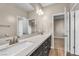 Modern bathroom features double vanity with stone countertop and neutral color palette at 9091 Becket Ranch Ct, Las Vegas, NV 89113