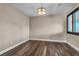 Neutral bedroom with hardwood floors and a modern ceiling light at 9091 Becket Ranch Ct, Las Vegas, NV 89113