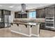 Beautiful kitchen featuring stainless steel appliances, dark cabinetry, and a granite countertop island with a cooktop at 9091 Becket Ranch Ct, Las Vegas, NV 89113