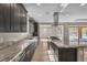 Kitchen featuring granite counters, stainless appliances, island cooktop, and open layout at 9091 Becket Ranch Ct, Las Vegas, NV 89113