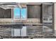 A closer view of the kitchen featuring granite countertops, stainless steel appliances, and dark wood cabinets at 9091 Becket Ranch Ct, Las Vegas, NV 89113