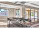 Kitchen island with cooktop, granite countertop, pendant lights, and sliding glass doors leading to the backyard at 9091 Becket Ranch Ct, Las Vegas, NV 89113