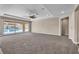 Spacious living room with large sliding glass doors that open to a backyard swimming pool at 9091 Becket Ranch Ct, Las Vegas, NV 89113