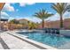 Inviting pool area featuring palm trees, water features, and comfortable seating for outdoor relaxation and entertainment at 9091 Becket Ranch Ct, Las Vegas, NV 89113